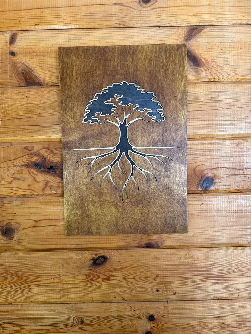Handcrafted layered wood art featuring a tree with roots, perfect for rustic home decor