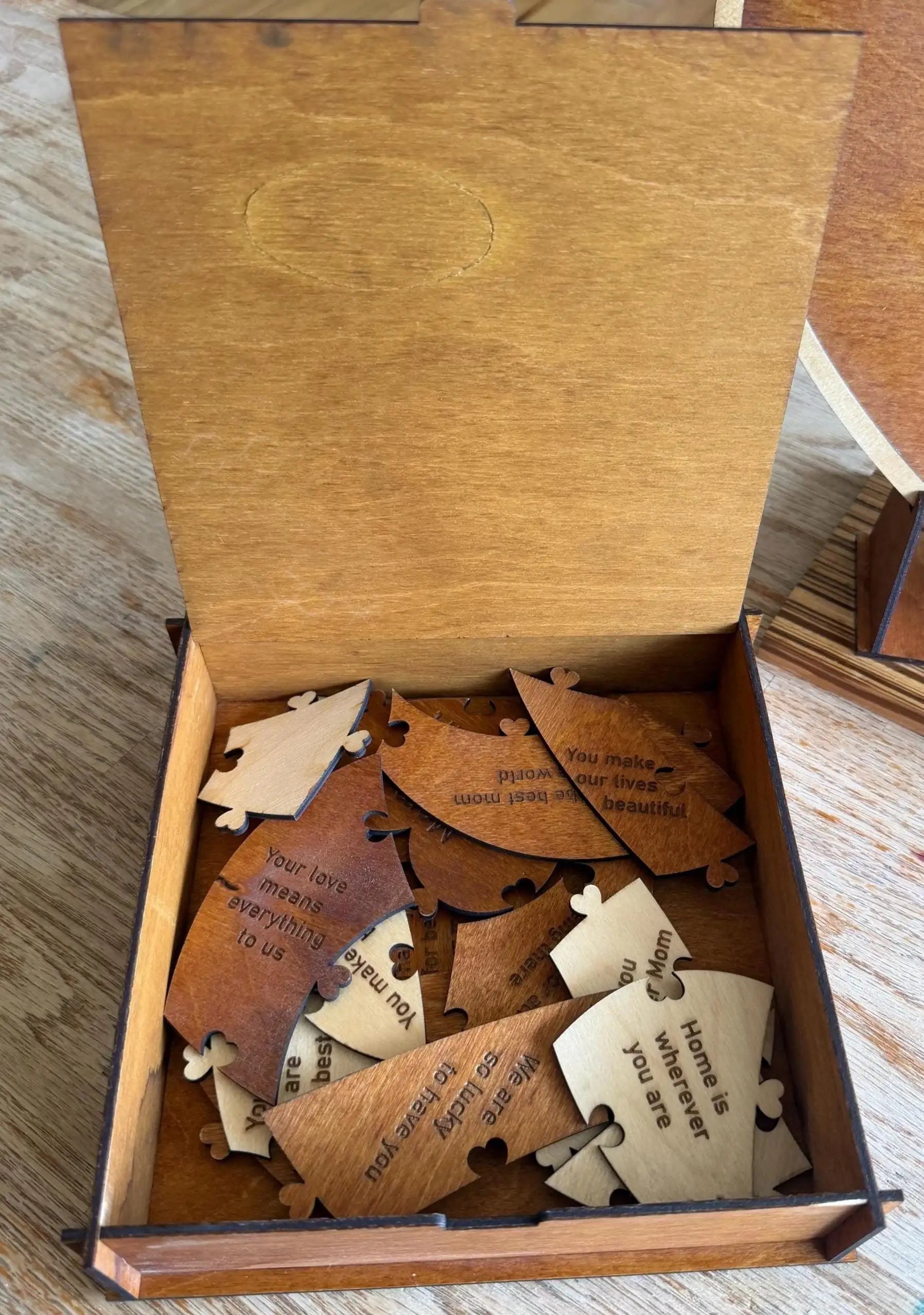 Handcrafted wooden puzzle pieces with heartfelt messages in a laser-cut box, perfect for custom gifts and home decor.