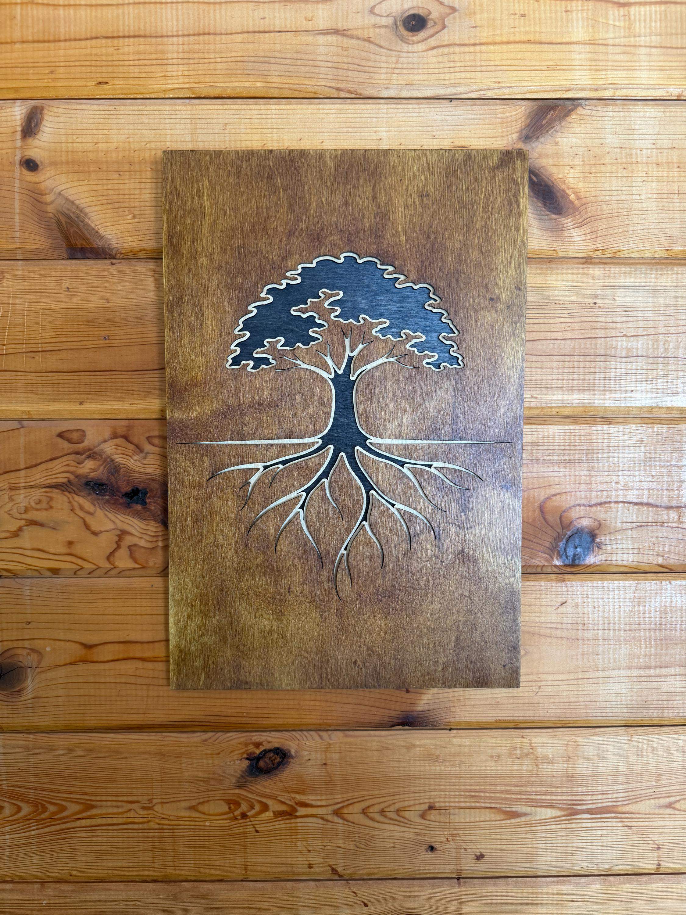 Layered wood art of a tree with roots, handcrafted laser-cut wall decor on rustic wood background