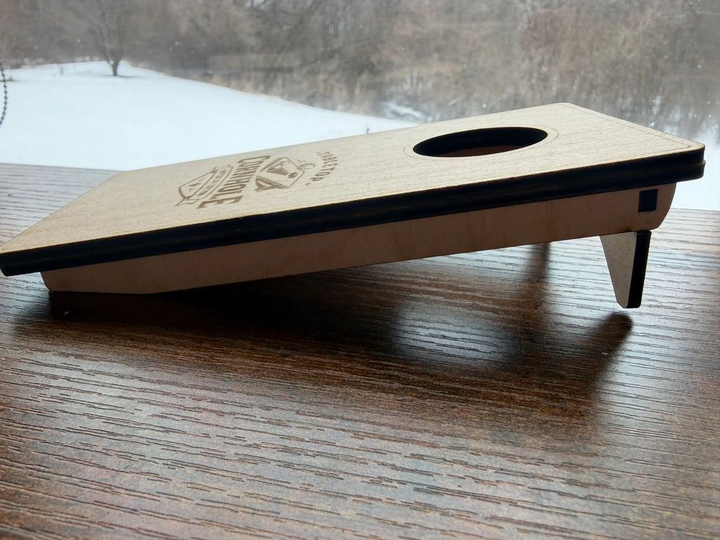 Handcrafted wooden tabletop cornhole game with laser-cut design, perfect for indoor fun and rustic decor.