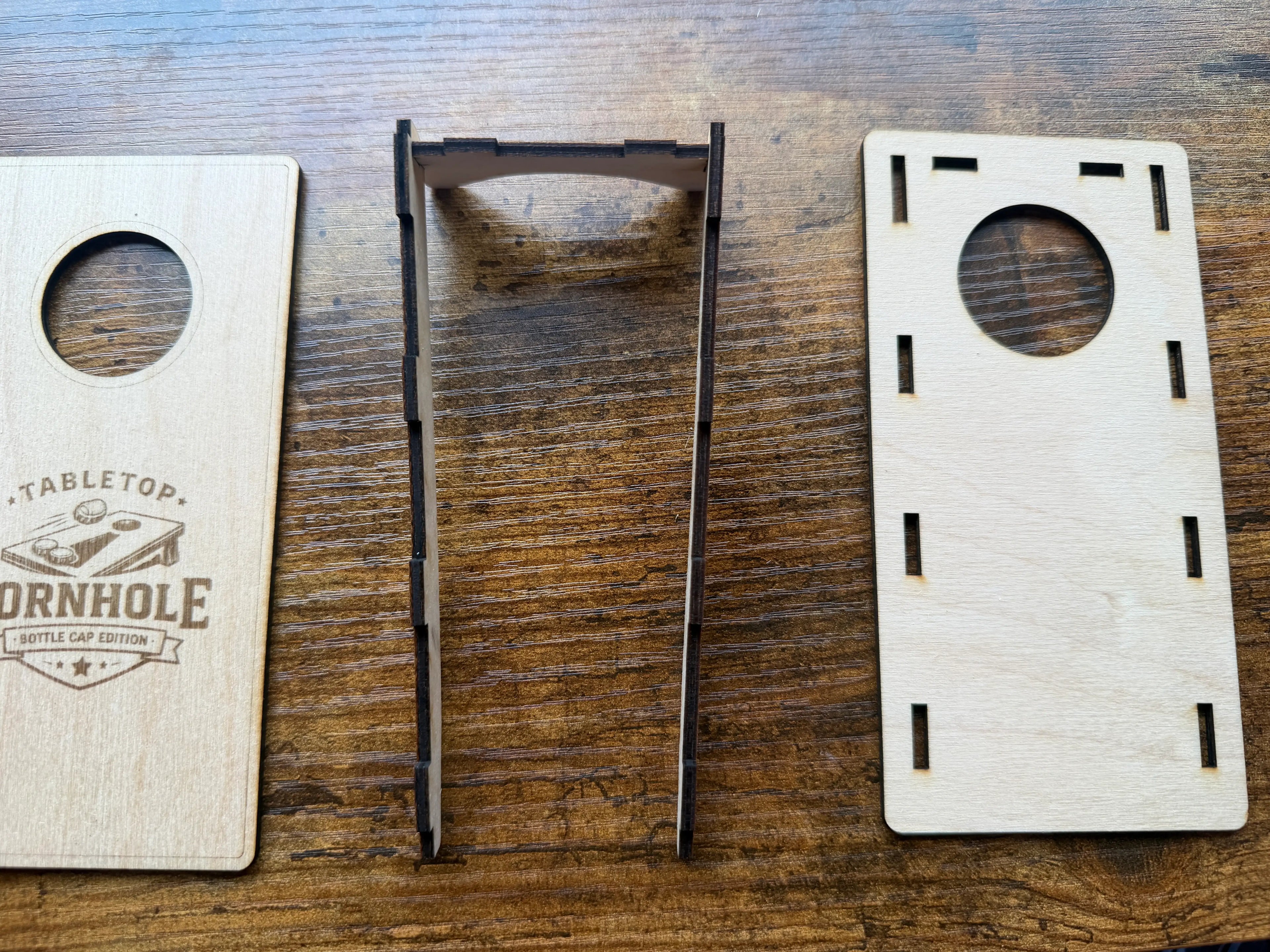 Tabletop cornhole game set with laser-cut wood pieces and bottle cap edition design