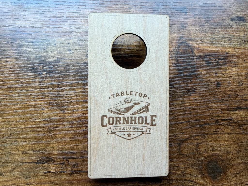 Tabletop Cornhole Bottle Cap Edition laser-cut wood game on rustic surface