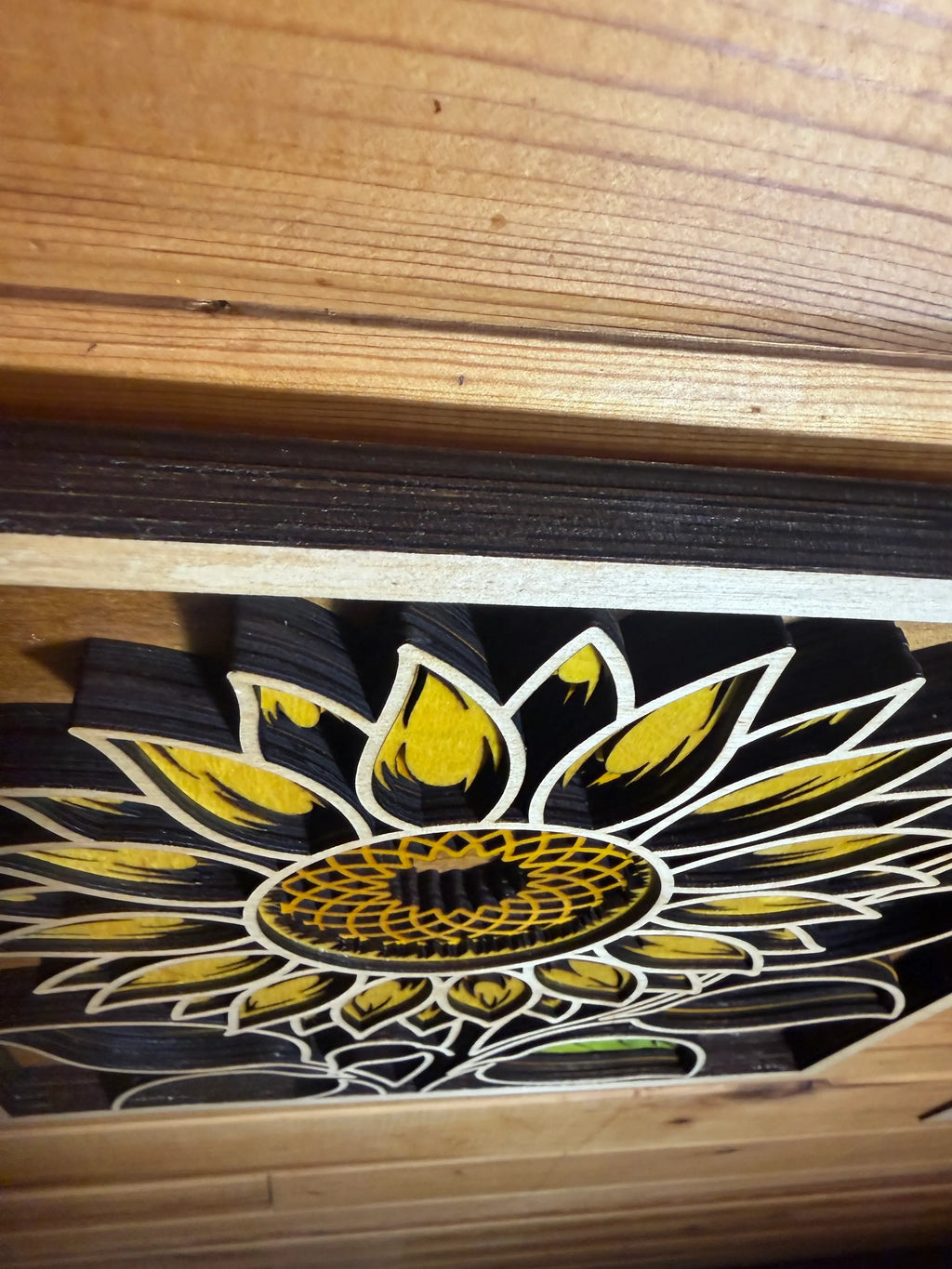 Layered wood sunflower art with yellow petals and intricate laser-cut details