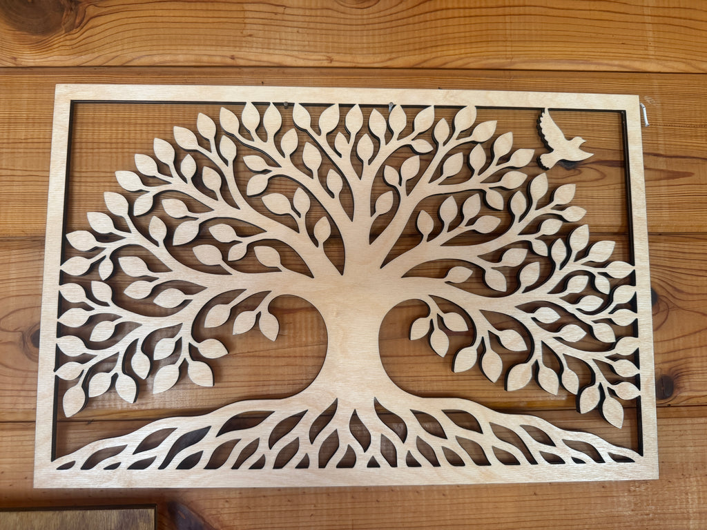 Laser-cut wooden tree of life wall art with intricate leaves and roots, perfect for rustic home decor.