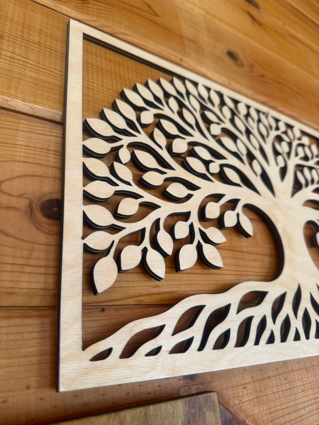 Layered wood art tree with intricate leaf design, handcrafted laser-cut decor