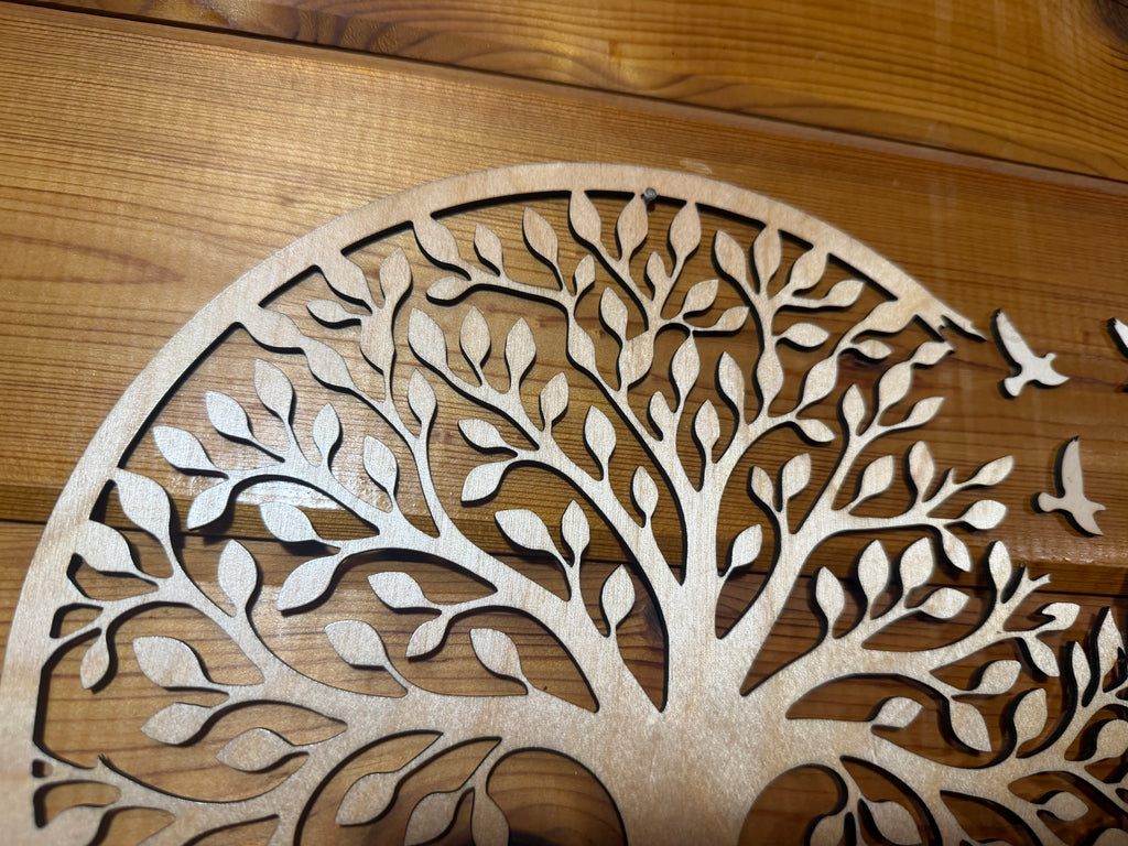 Laser-cut wooden tree of life wall art with intricate leaf and bird details