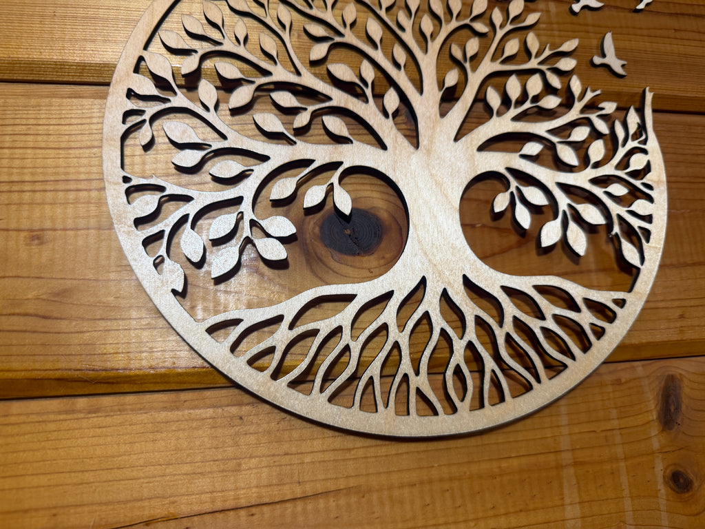 Laser-cut wooden tree of life art with intricate roots and leaves, perfect for rustic home decor.