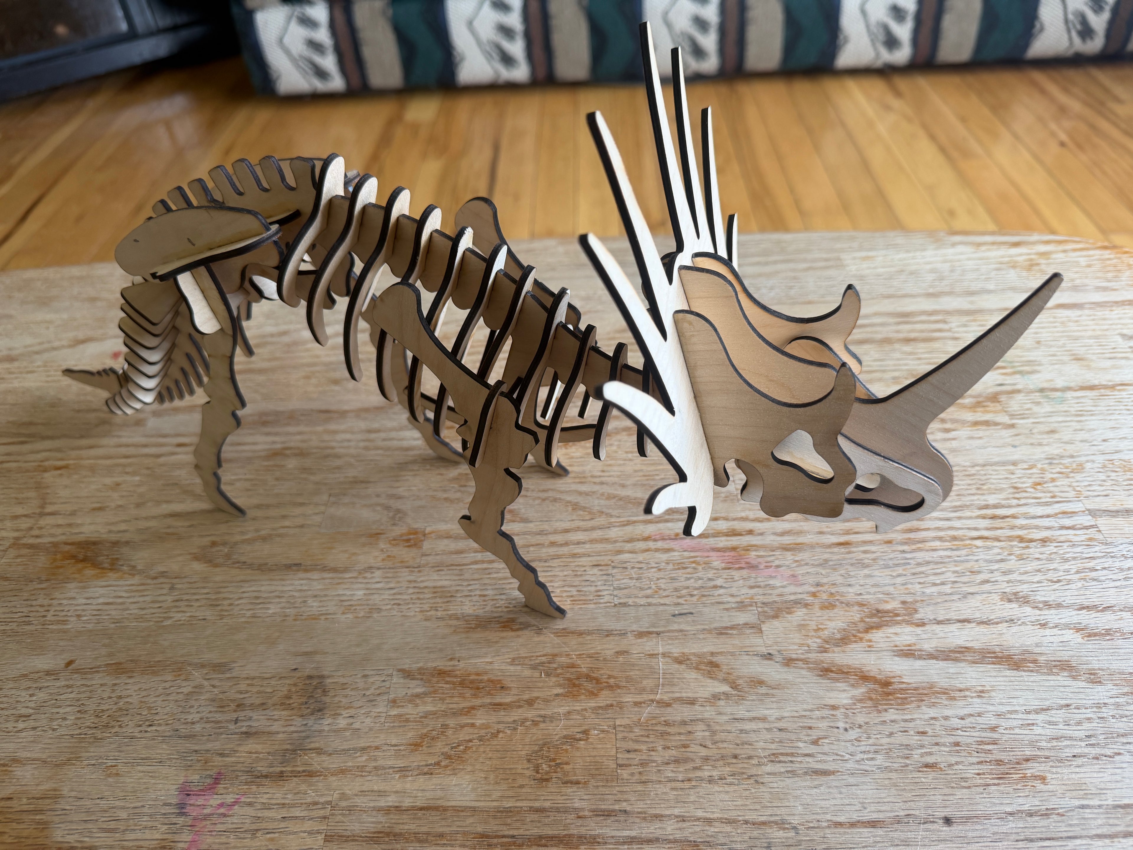 Handcrafted wooden Triceratops skeleton art, laser-cut layered decor for unique home styling