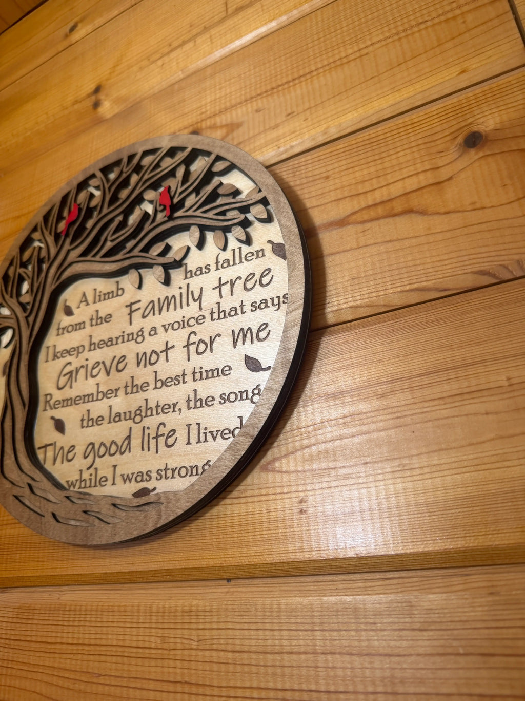 Layered wood family tree art with engraved poem, mounted on rustic wooden wall