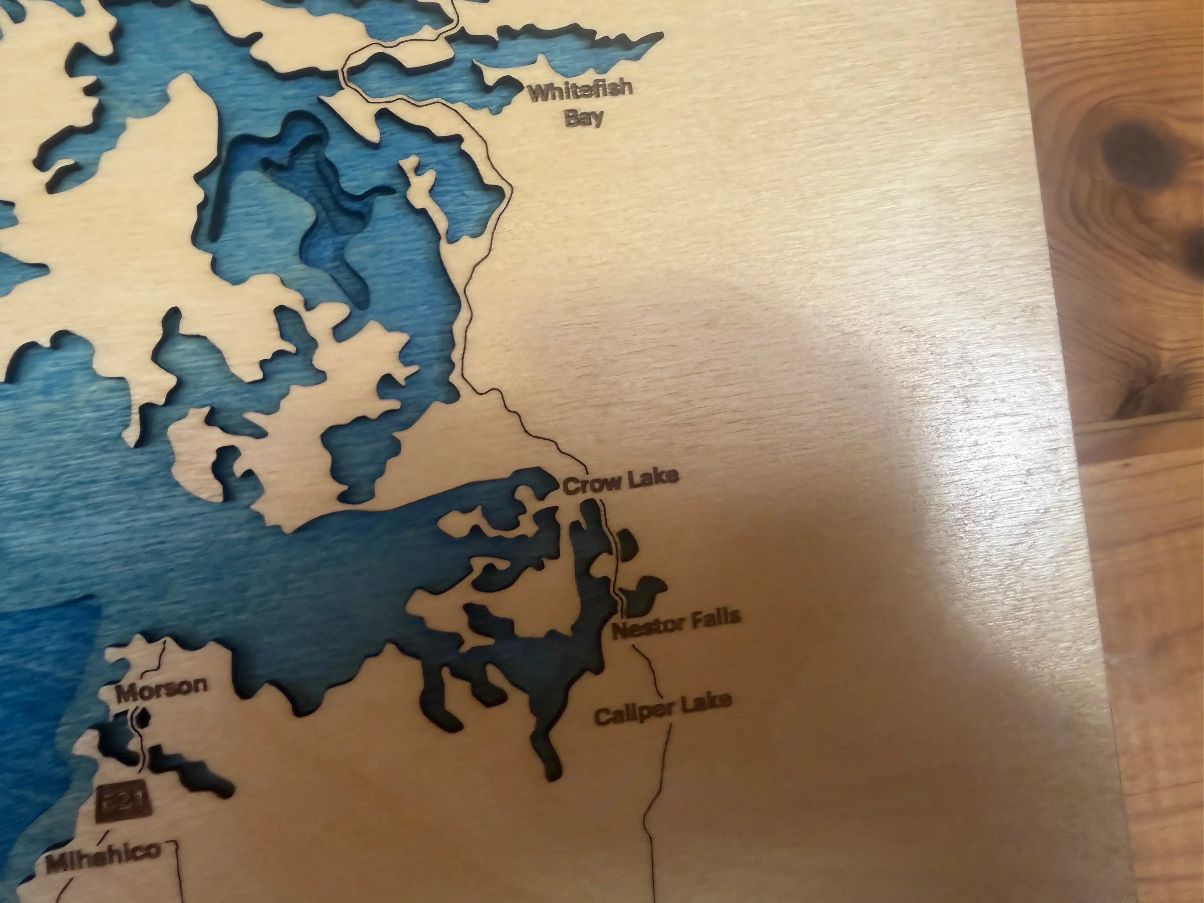 Layered wood lake map featuring Crow Lake, Nestor Falls, and Whitefish Bay, handcrafted decor
