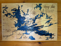 Handcrafted wooden map of Rainy Lake, USA-Canada border, featuring layered blue depth contours and engraved landmarks for rustic wall decor.
