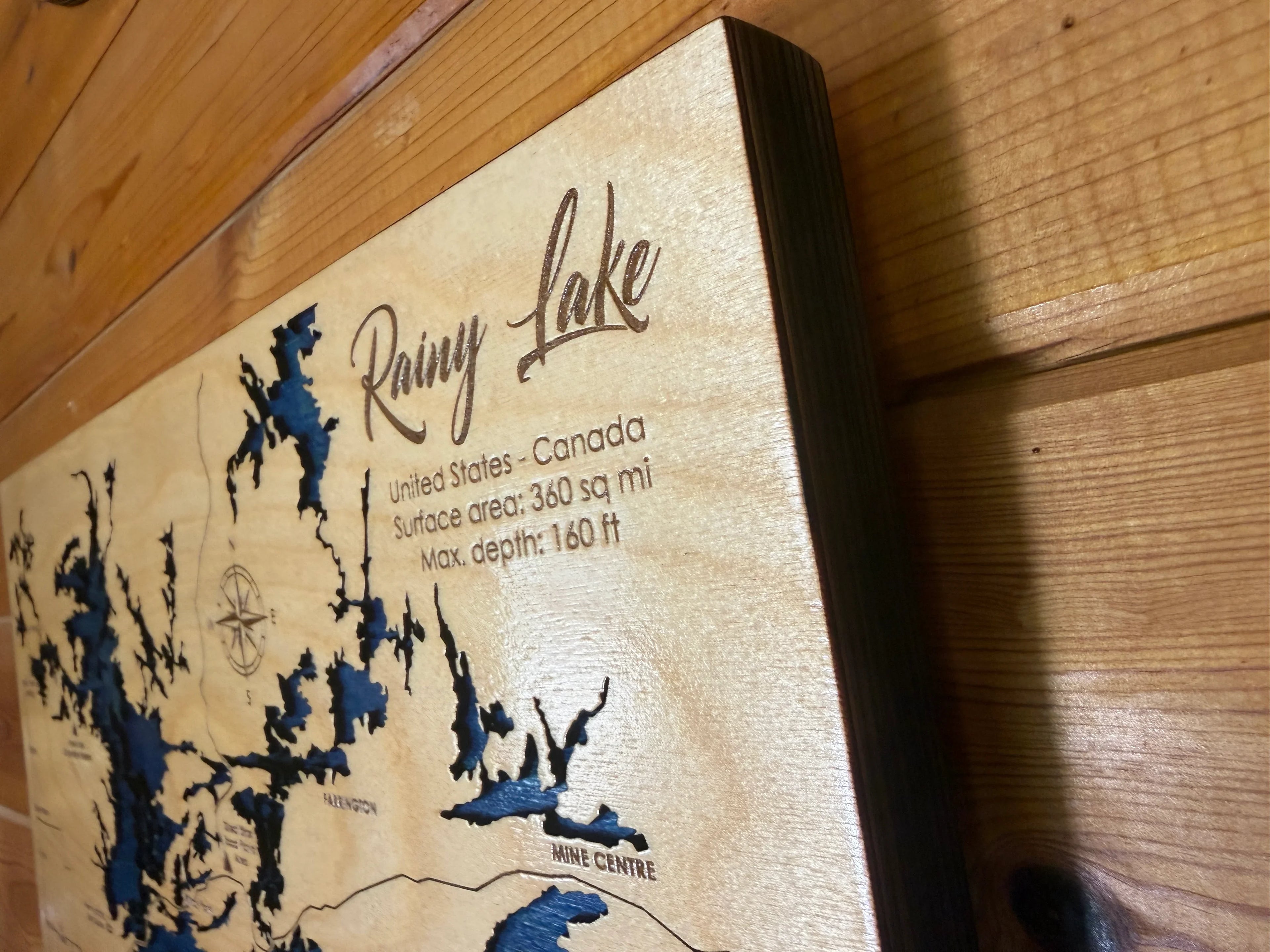 Handcrafted wooden Rainy Lake map art with laser-cut details, perfect for rustic home decor or lake house gifts.