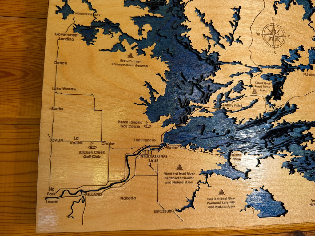 Handcrafted layered wood lake map with laser-cut details and natural wood finish