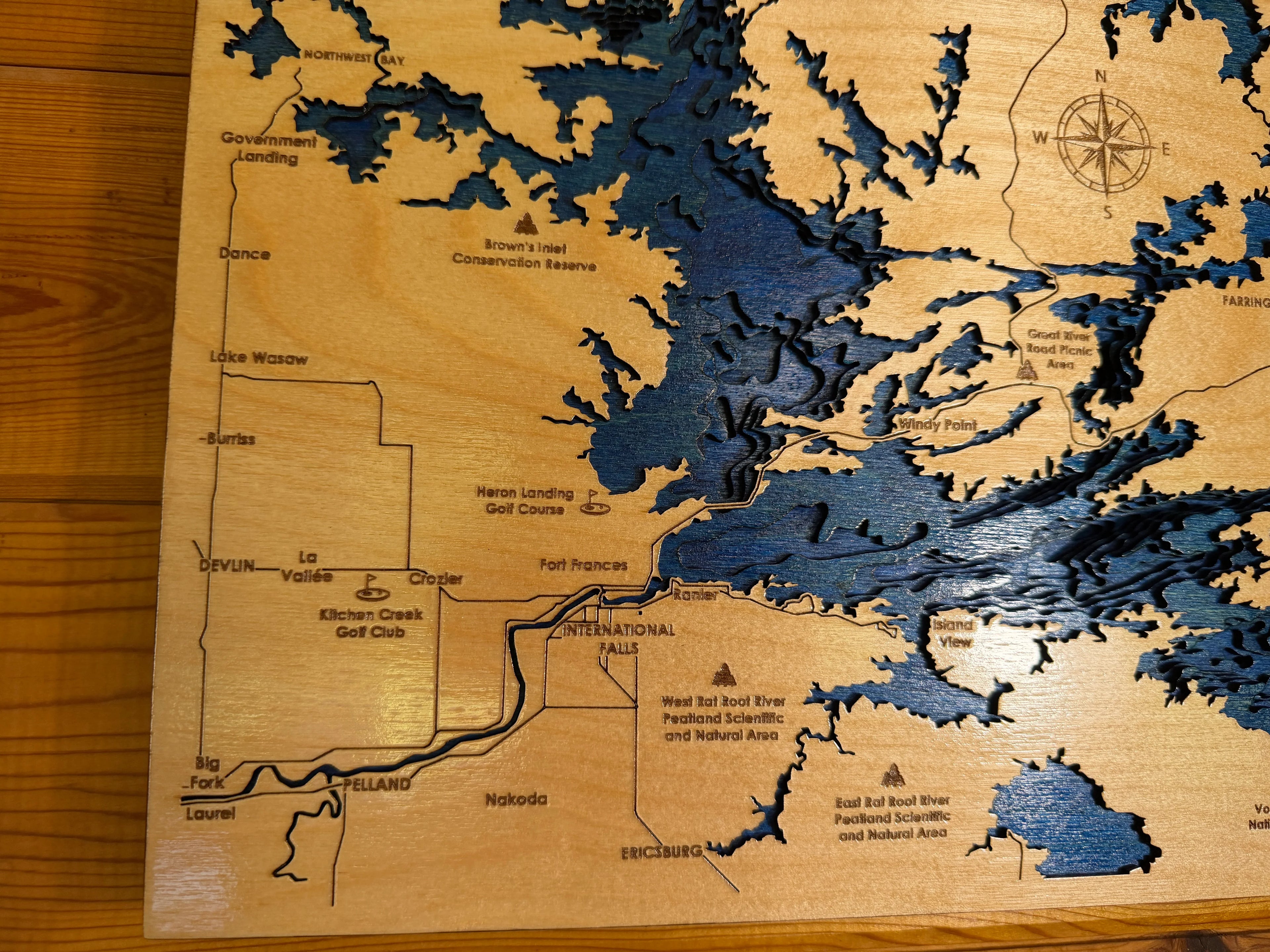 Handcrafted layered wood lake map with laser-cut details and natural wood finish