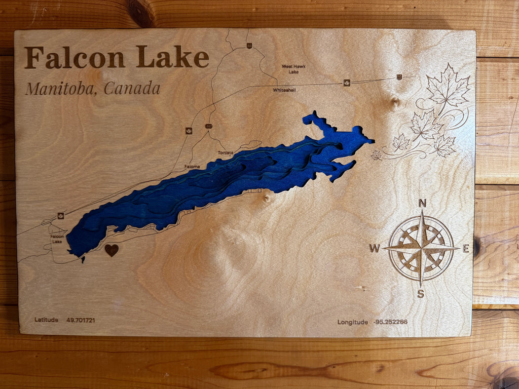 Layered wood art map of Falcon Lake, Manitoba, Canada with blue water design and compass rose