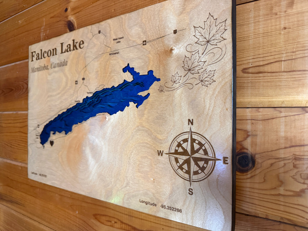 Handcrafted wooden Falcon Lake map art with blue layered water, compass rose, and maple leaves, Manitoba, Canada