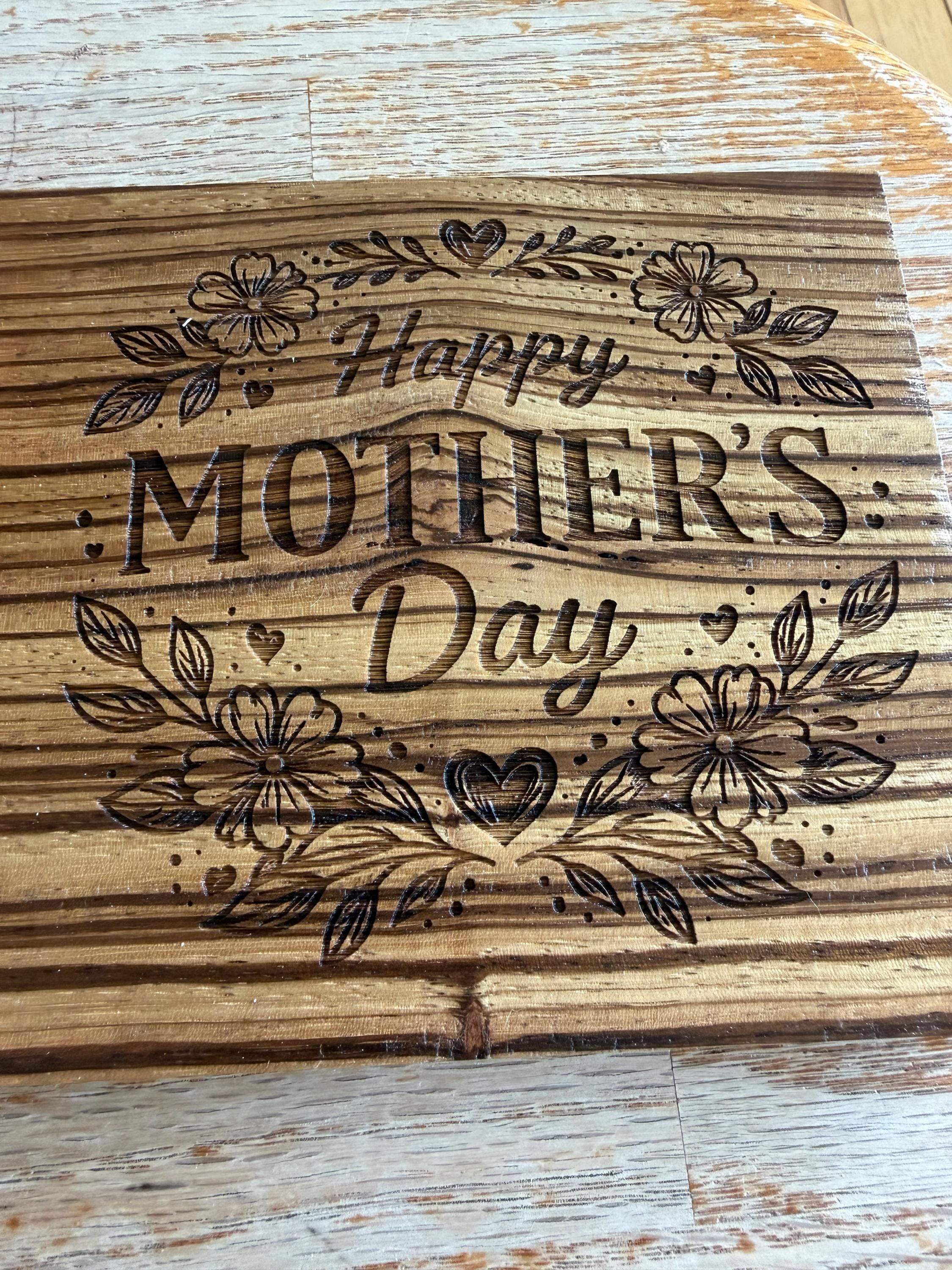 Handcrafted wooden Mother's Day sign with floral and heart designs, laser-cut for unique decor.