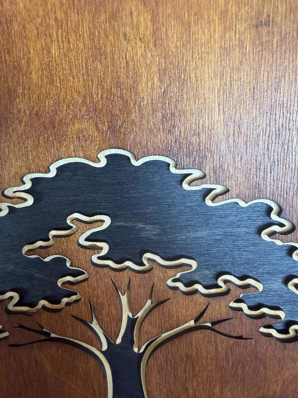 Layered wood tree art with intricate laser-cut branches and textured canopy, handcrafted decor
