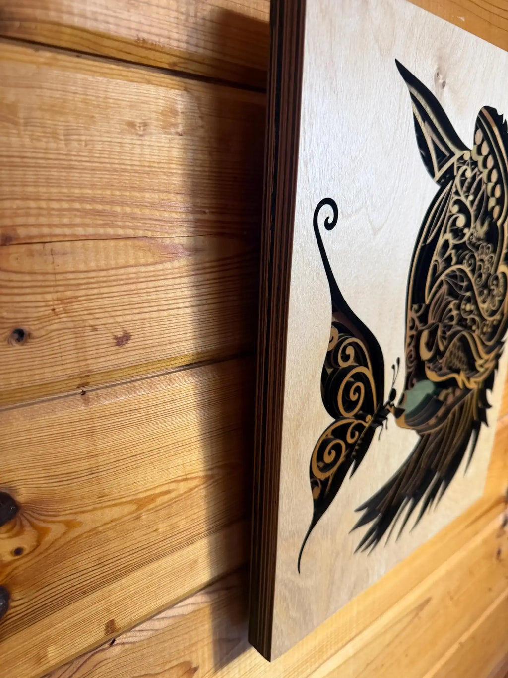 Layered wood art featuring intricate butterfly and owl design, handcrafted decor