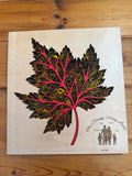 Custom layered wood art maple leaf with intricate patterns and family names, handcrafted decor