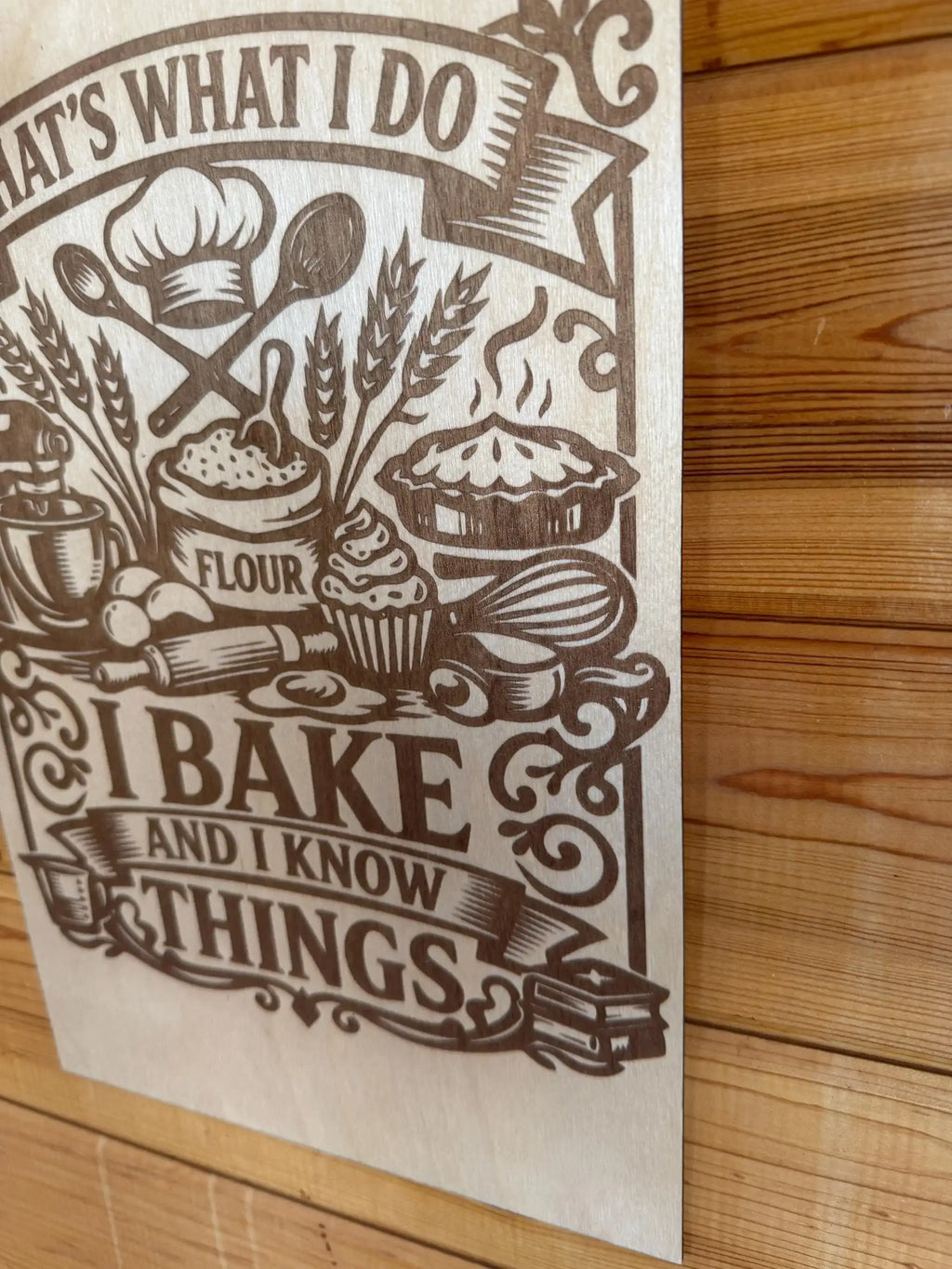 Laser-cut wood art with baking theme, featuring chef hat, flour, pie, and 'I bake and I know things' text.