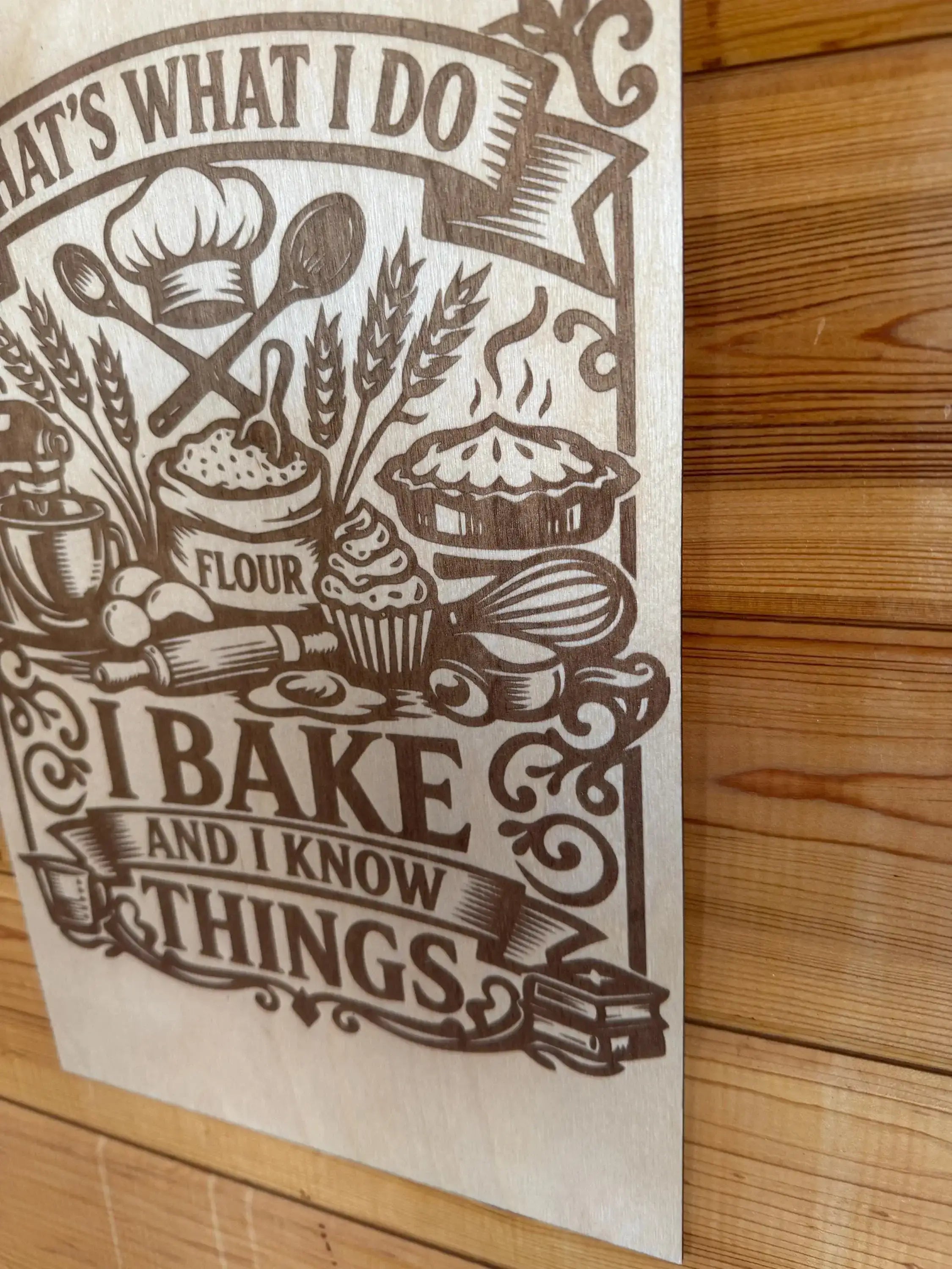 Laser-cut wood art with baking theme, featuring chef hat, flour, pie, and 'I bake and I know things' text.