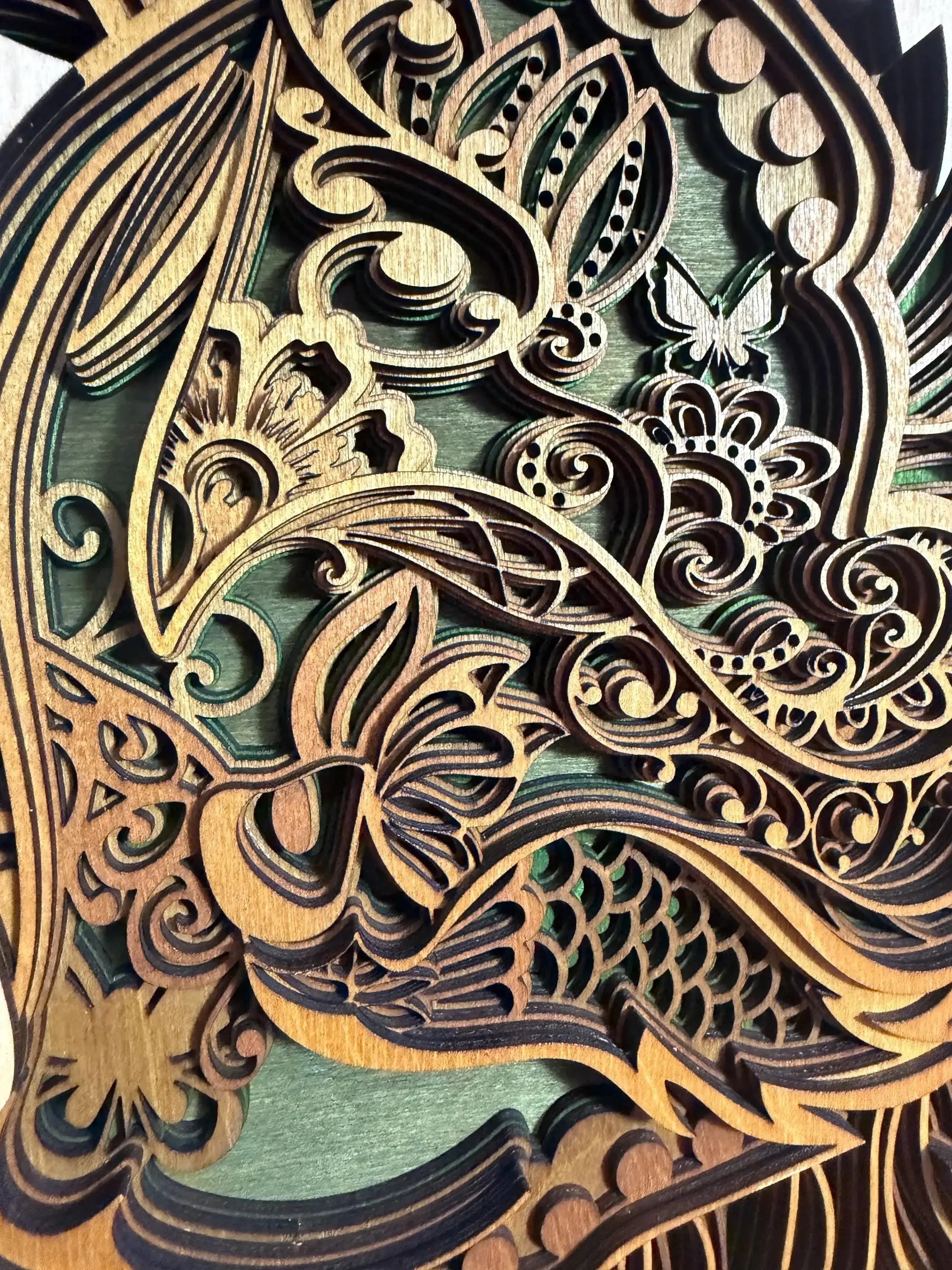 Intricate layered wood art with floral swirls and butterfly, handcrafted laser-cut decor