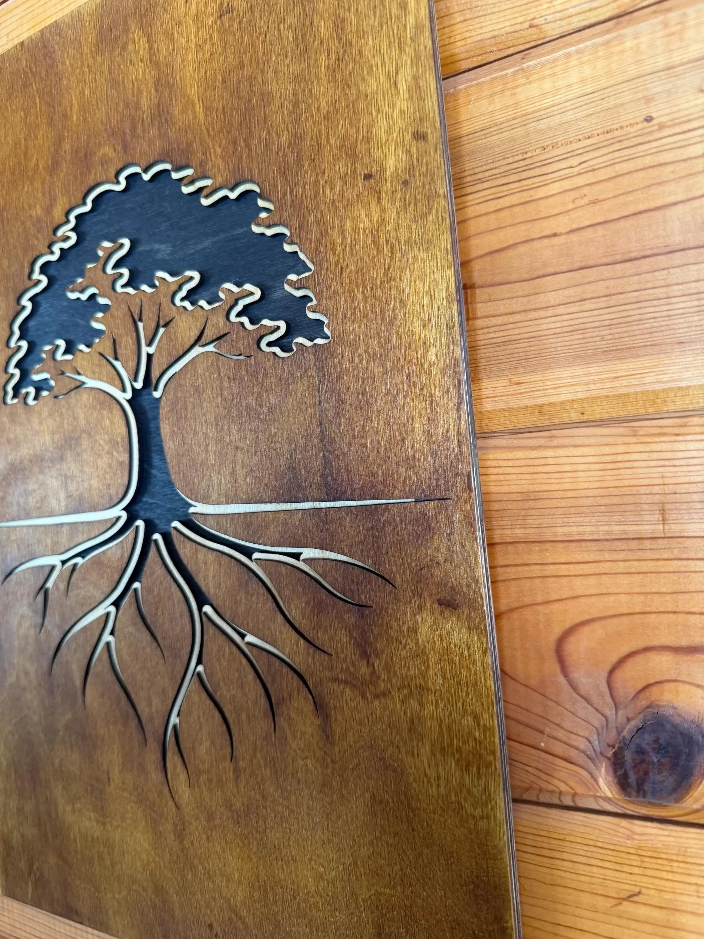 Handcrafted layered wood art featuring a tree with roots, laser-cut for rustic home decor.