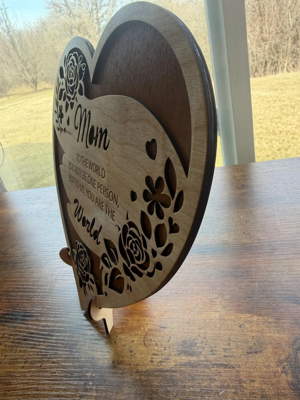 Heart-shaped wooden sign with floral cutouts and 'Mom' message, laser-cut decor for home